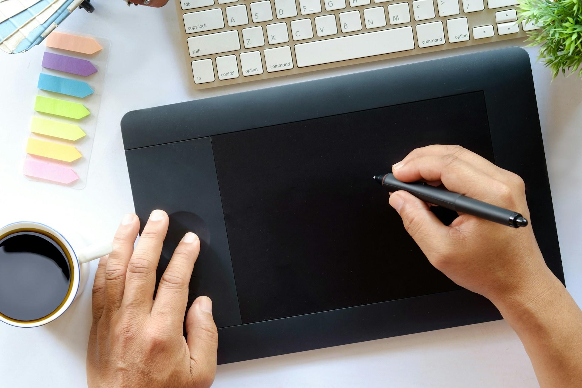Someone doing graphic design on their tablet.