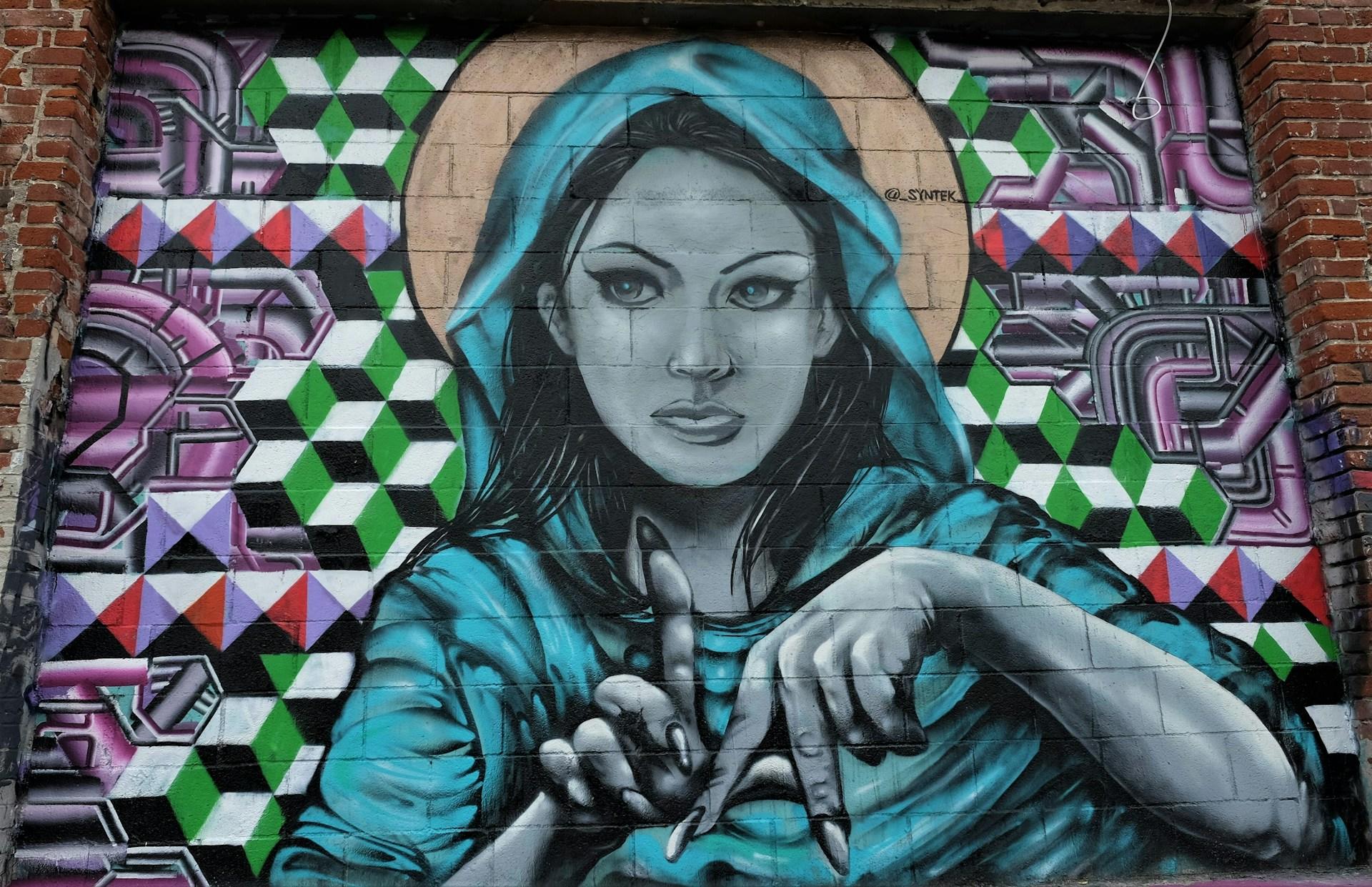 A graffiti art wall of a person making the 
