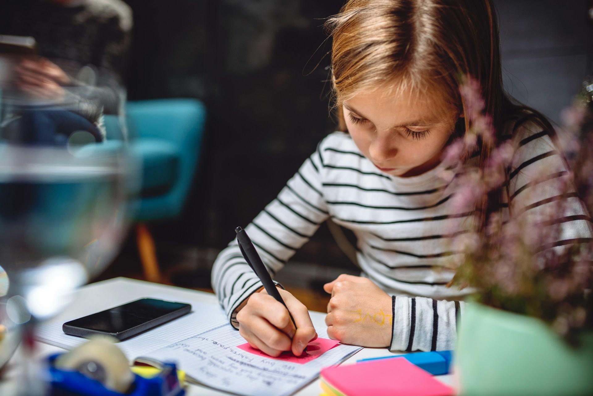 A girl studying at her desk.