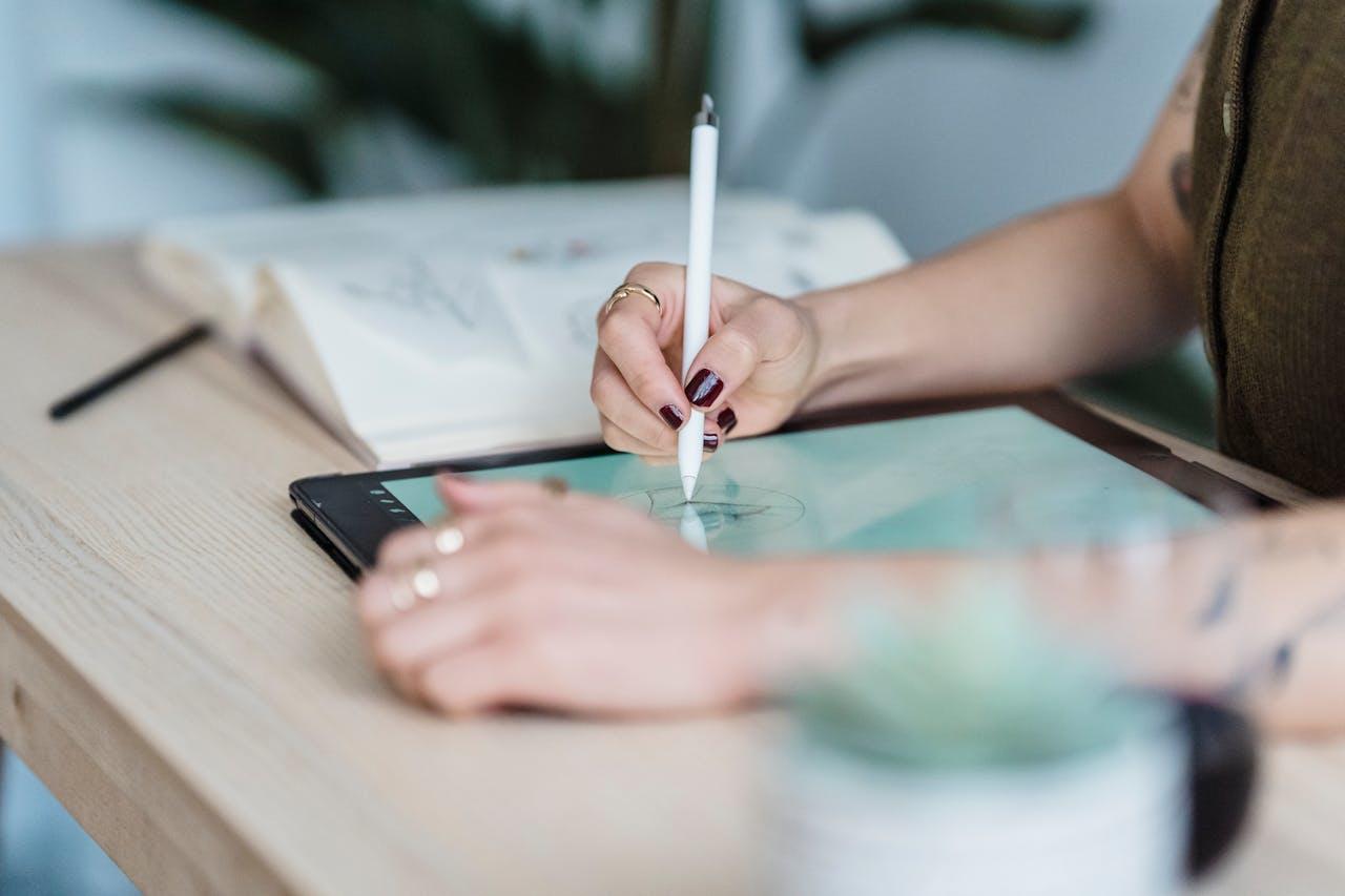 A student sketching on a tablet