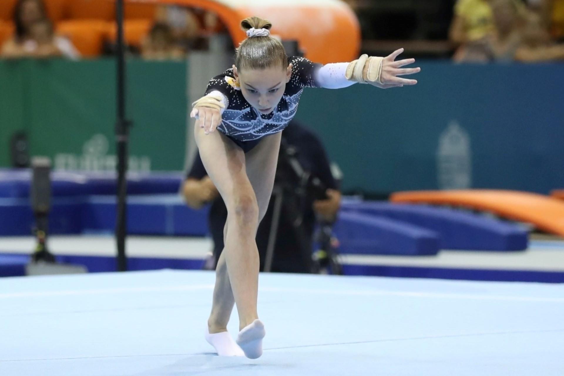 A gymnast during a floor routine.