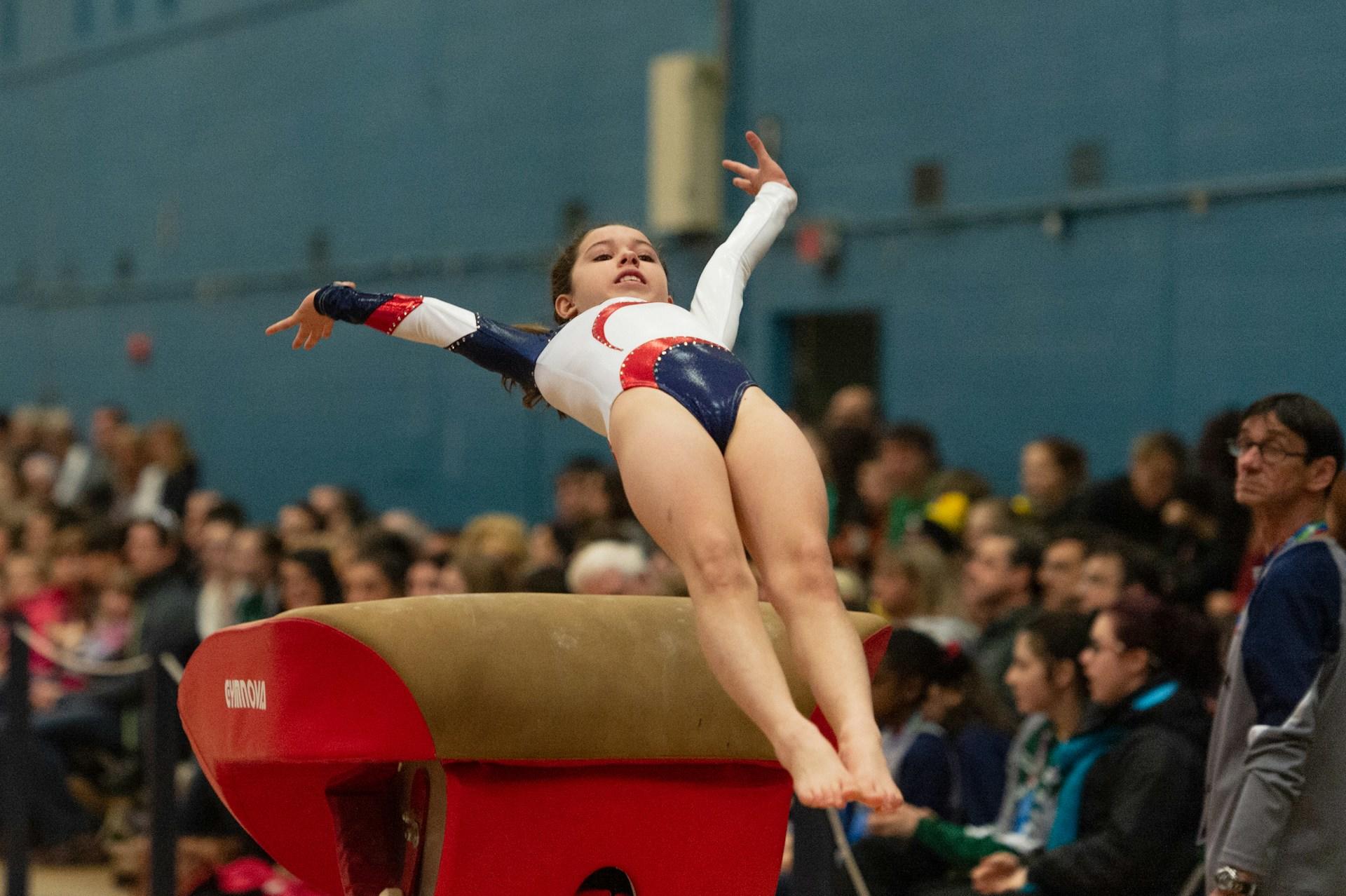 A gymnast performing a vault.