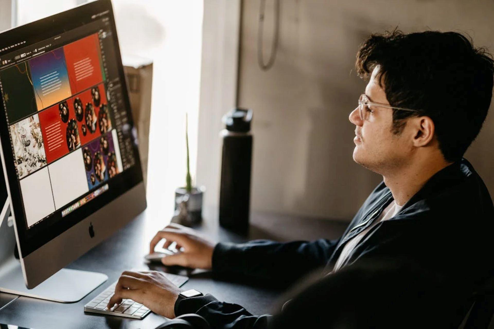 Graphic designer working on a computer with design software