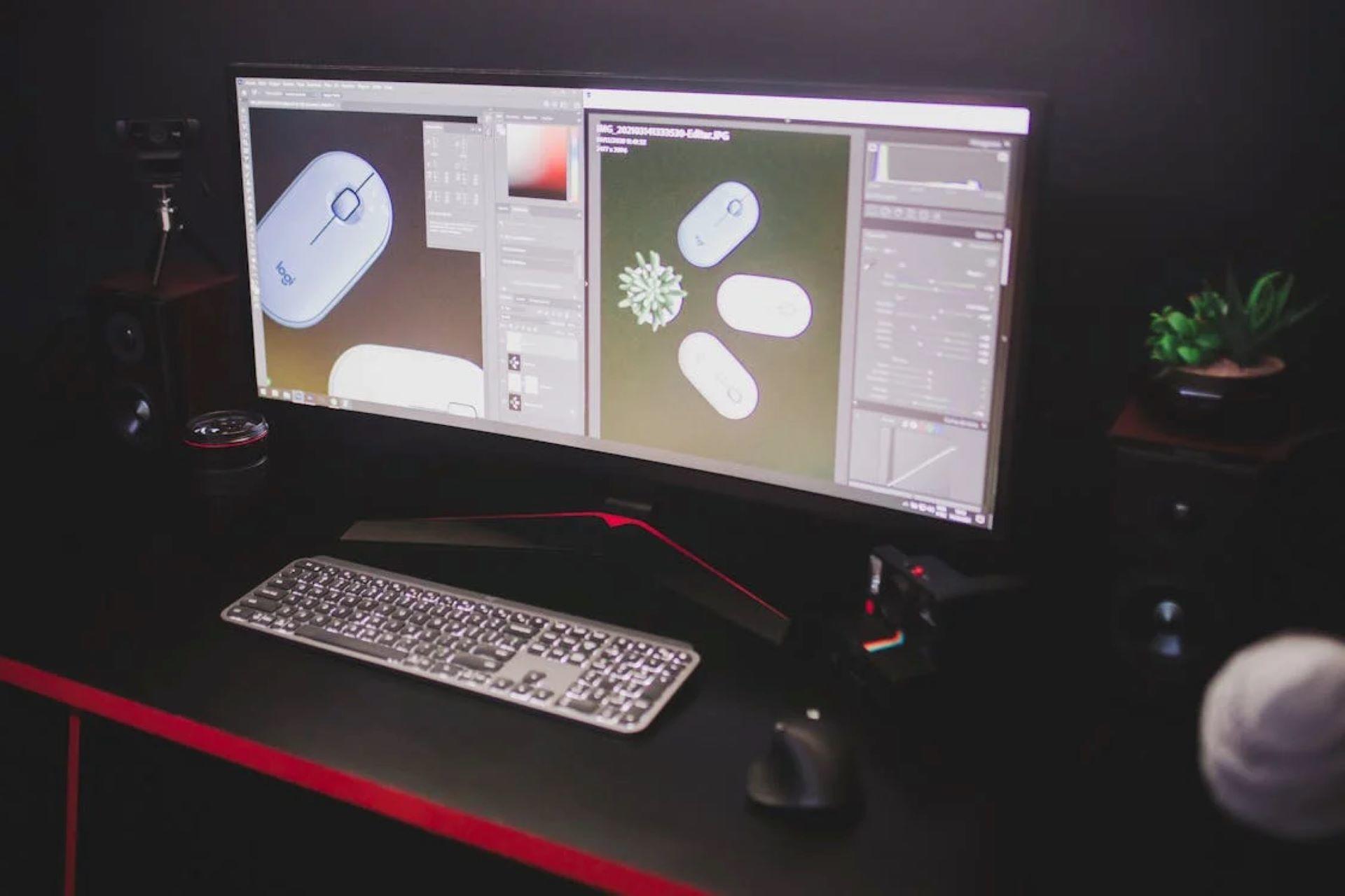 A large computer monitor with a keyboard and mouse on it