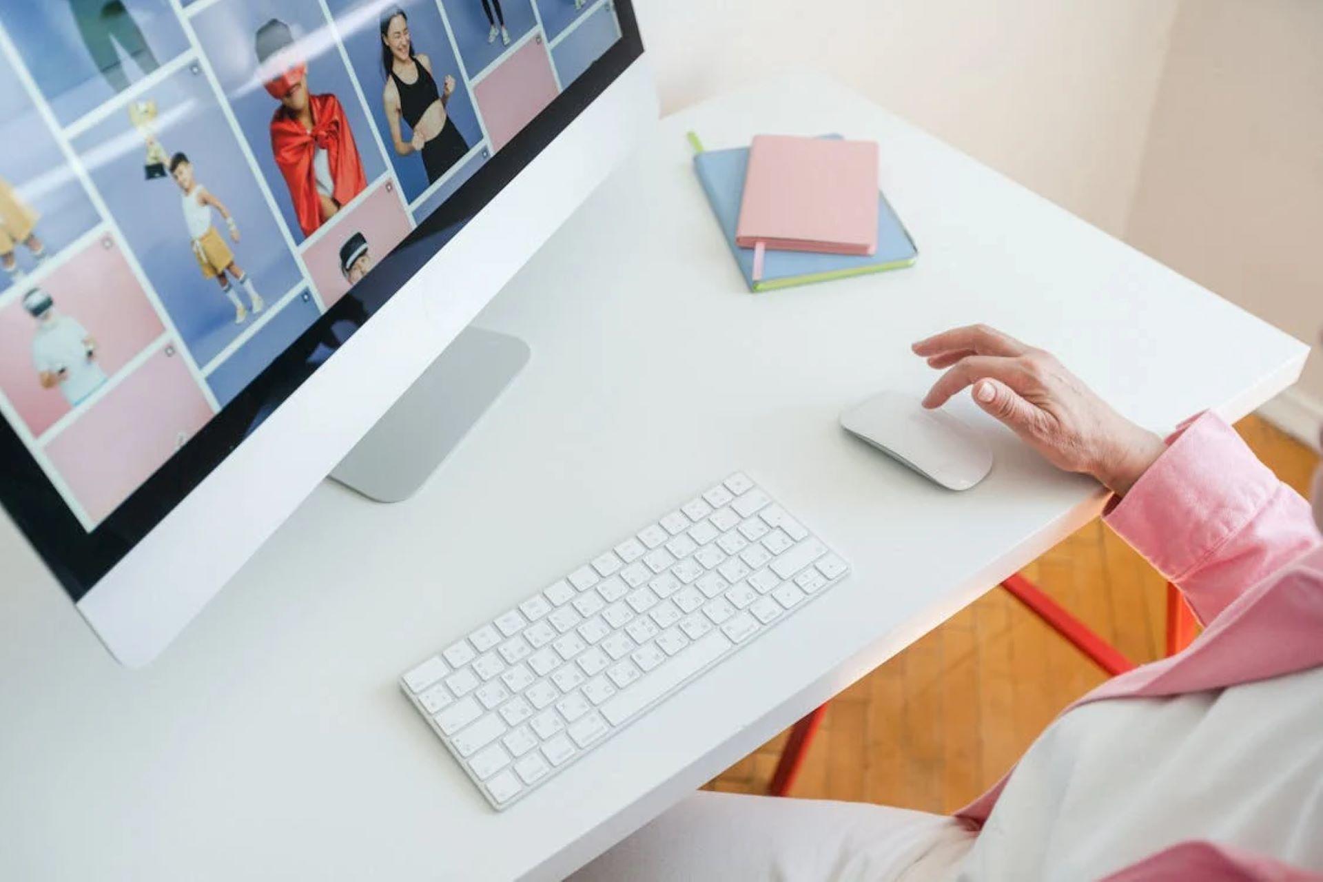 Woman using a computer to explore graphic design portfolios.