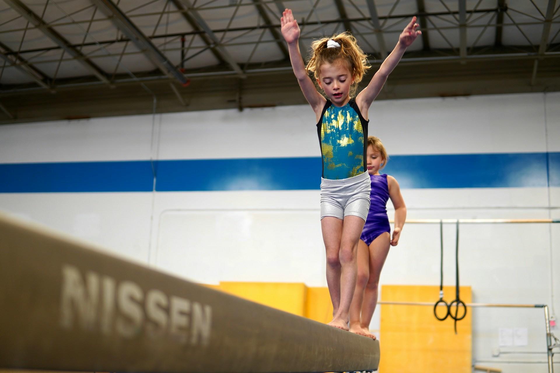 A girl on a balance beam.