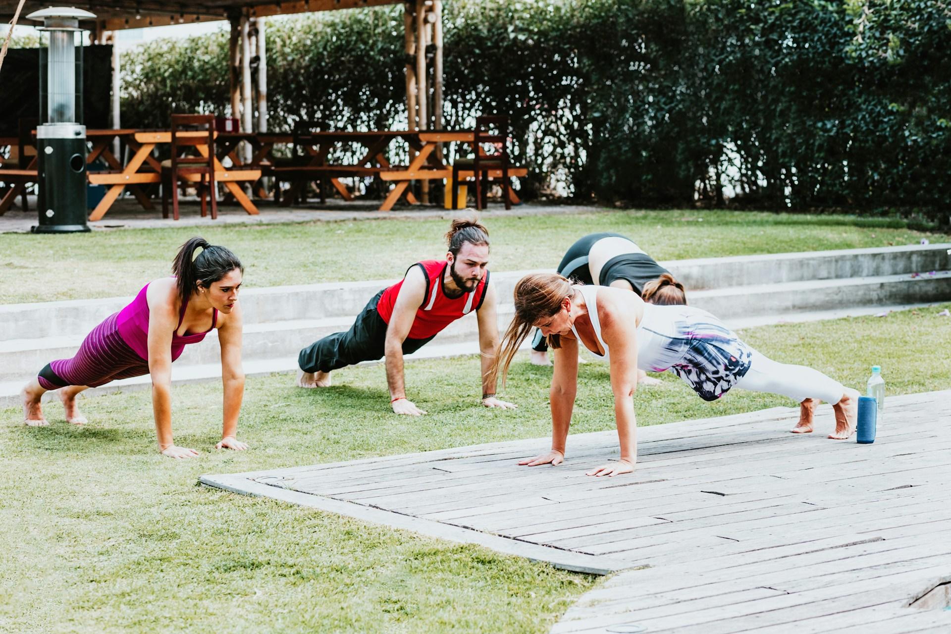 A workout group doing a plank