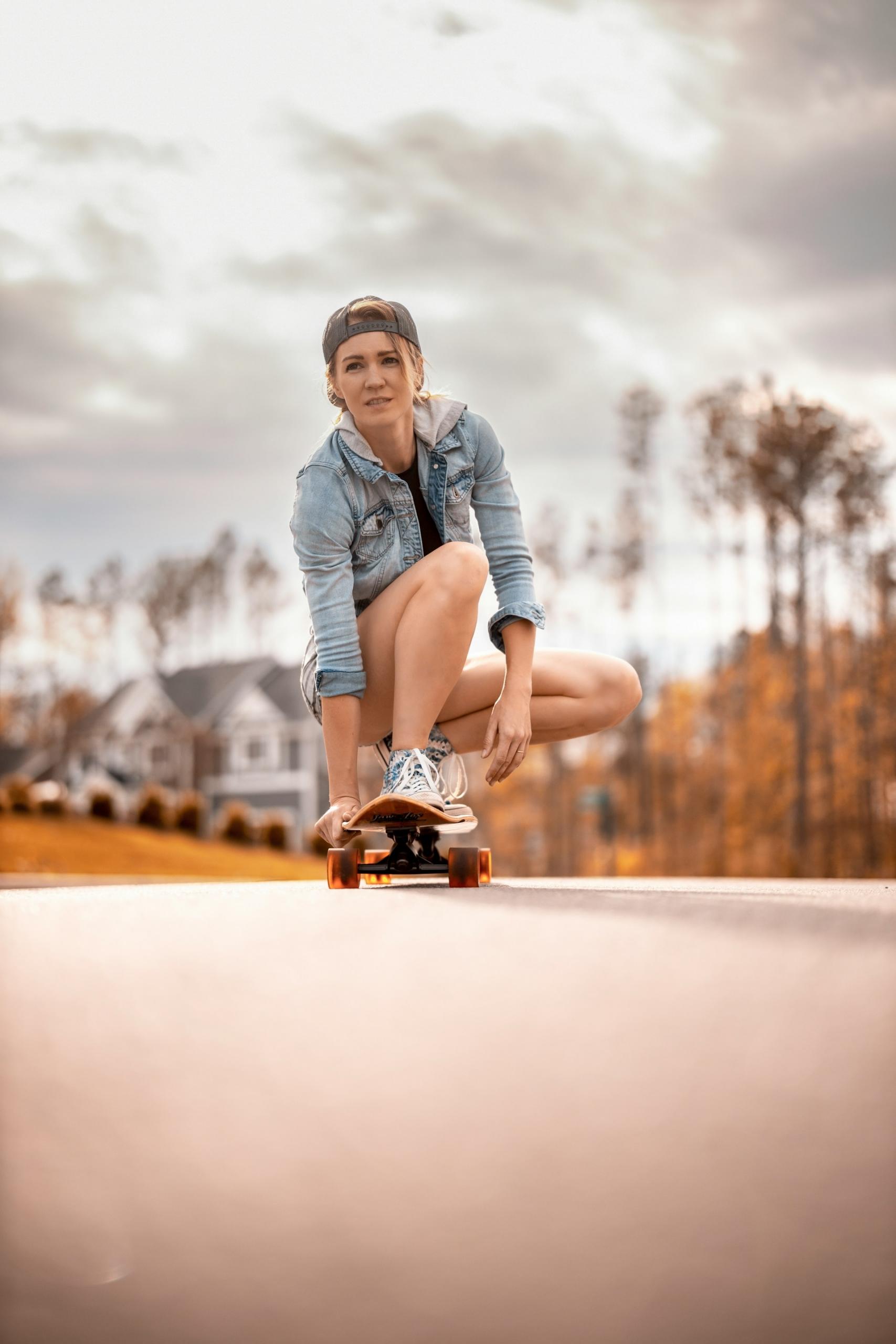 A skater crouching on the board while riding