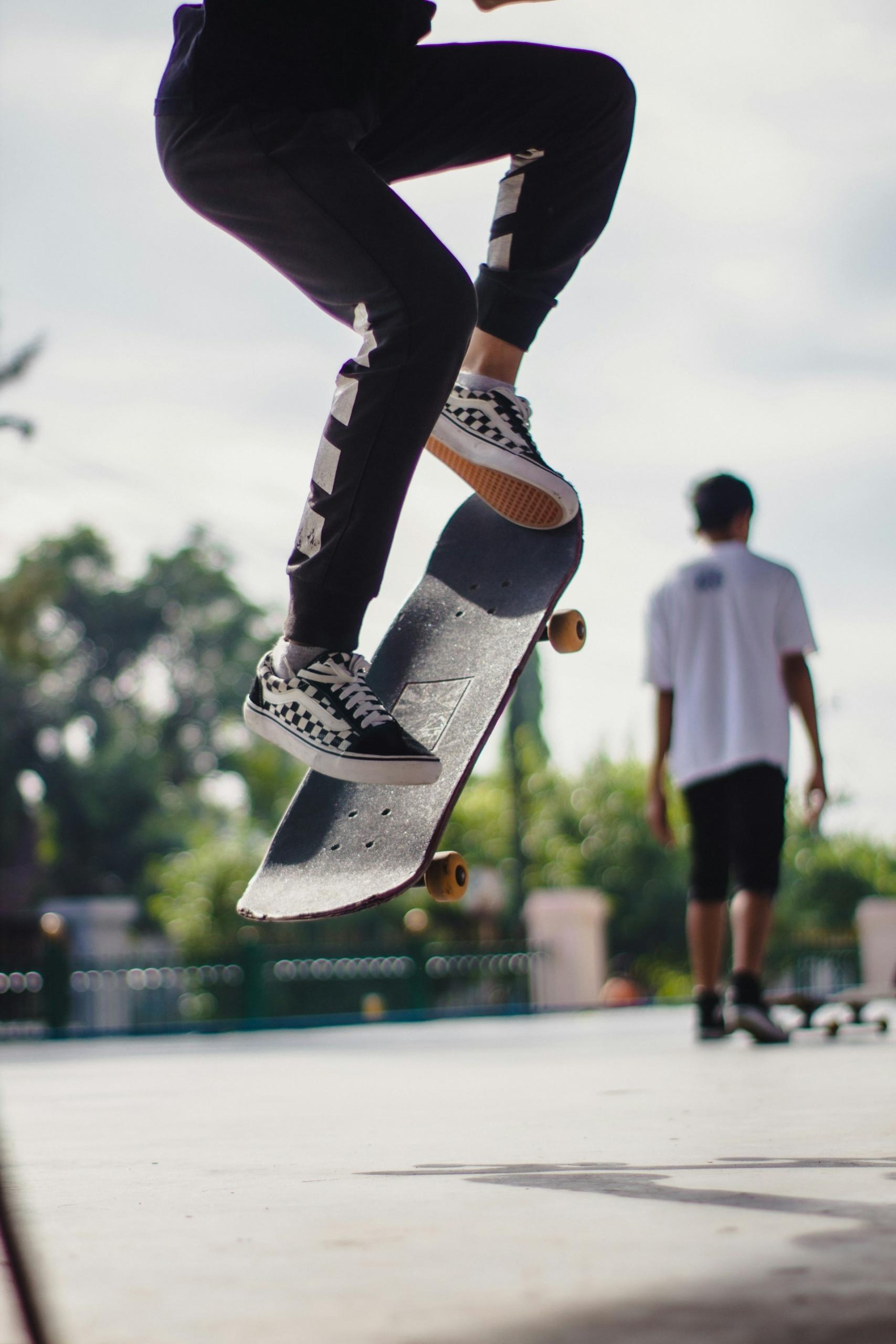 A skater performs an Ollie with the help of their grip tape