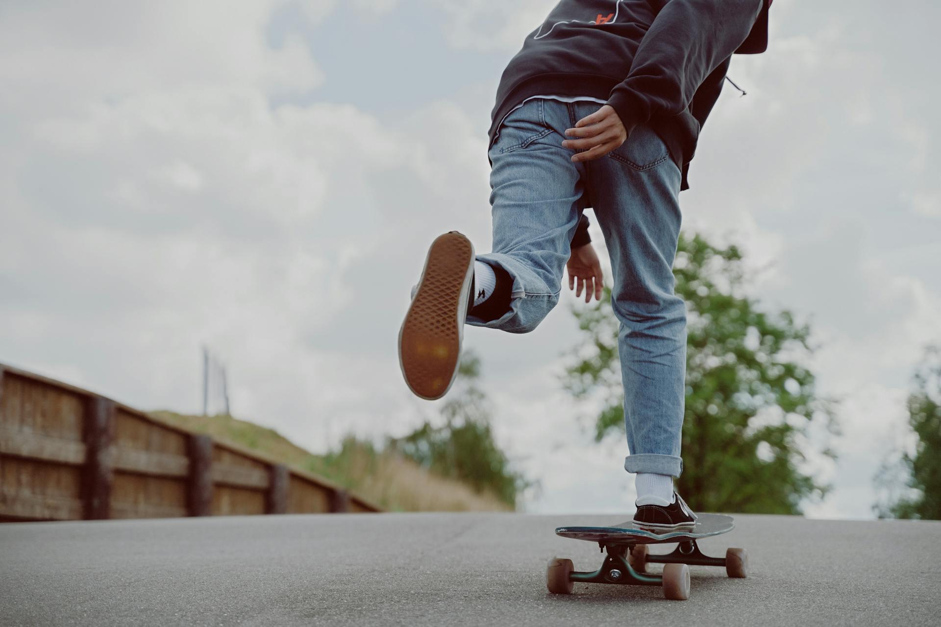 A skateboarder pushing with one foot still on the board