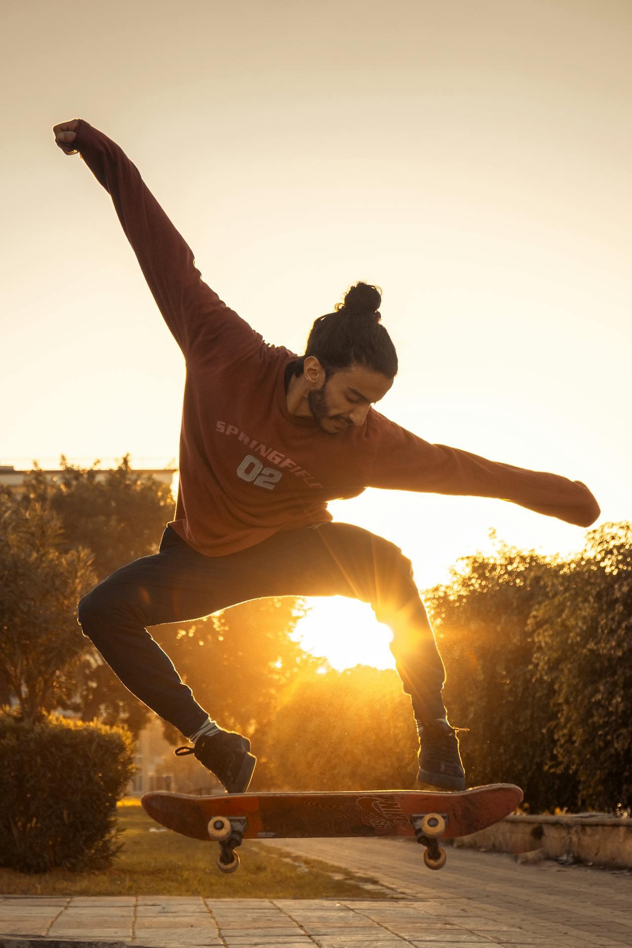A skater jumping and using their arms to help balance