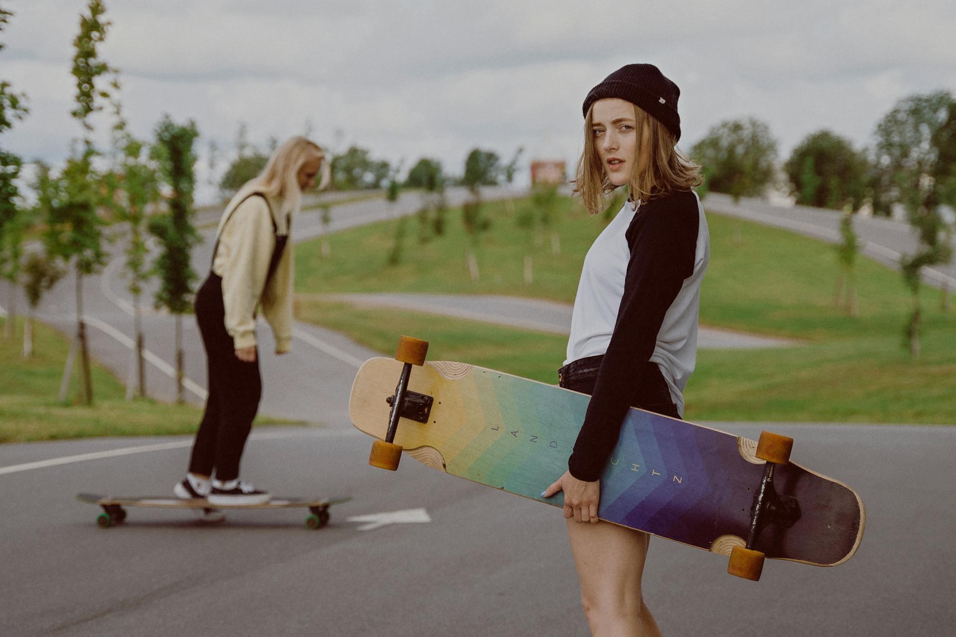 Two skateboarding girls with longboards