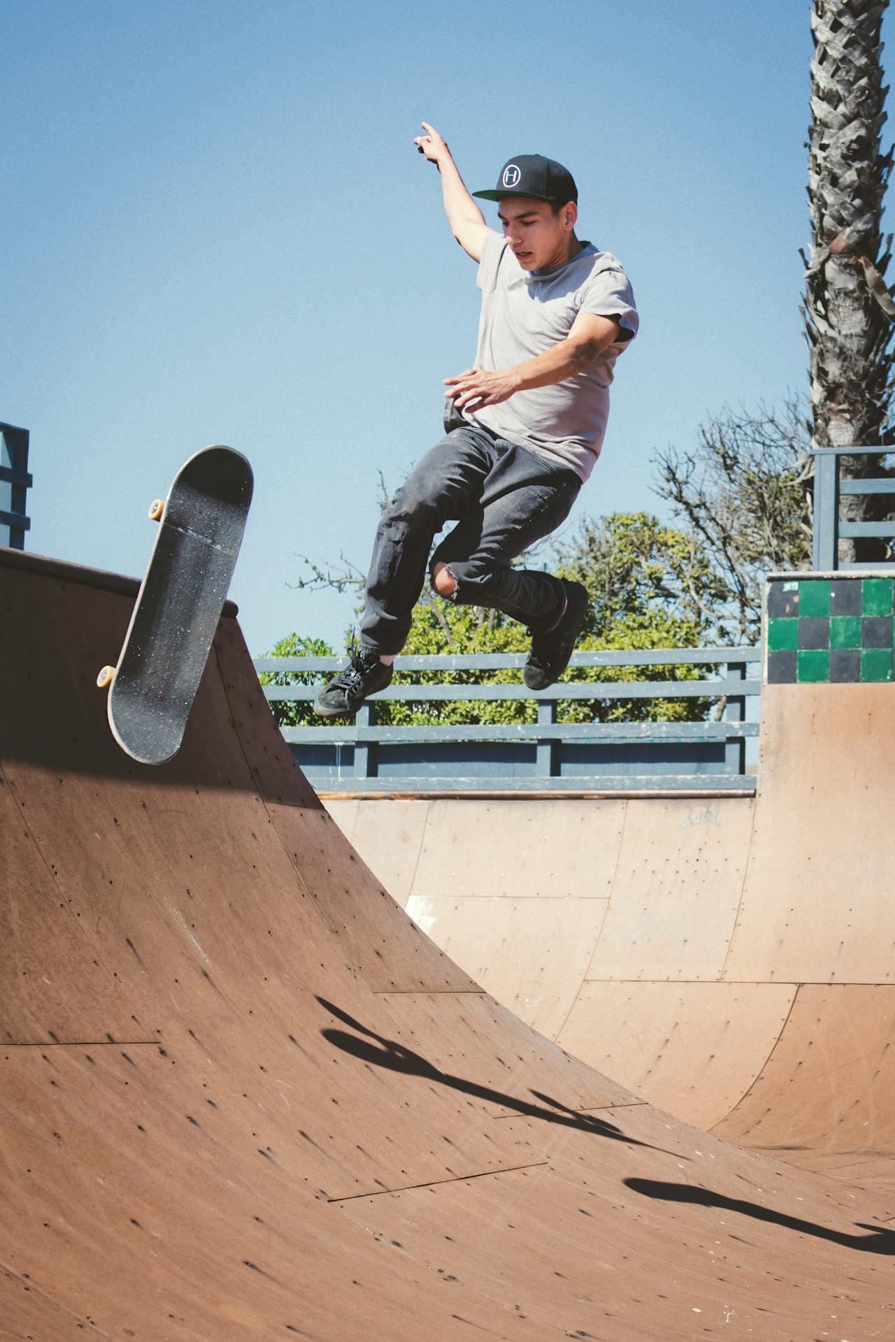 A skateboarder falling while trying to do a jump on a ramp