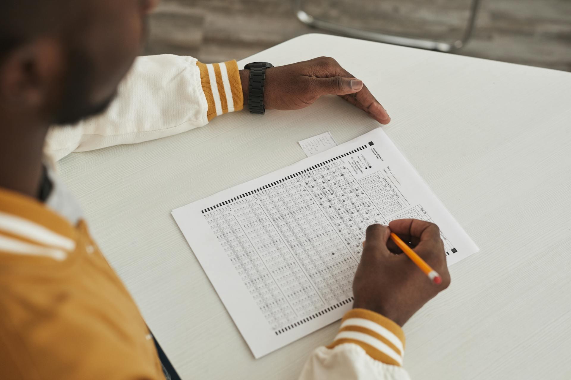 Someone holding a pencil, taking a standardized text.