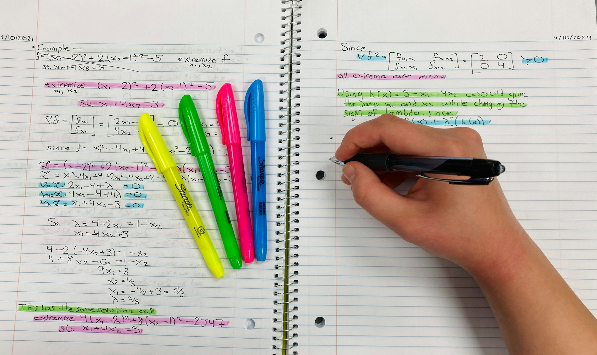 Highlights and someone writing on a lined notebook.