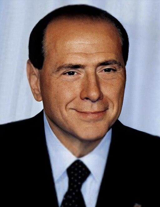 Silvio Berlusconi wearing a black suit.