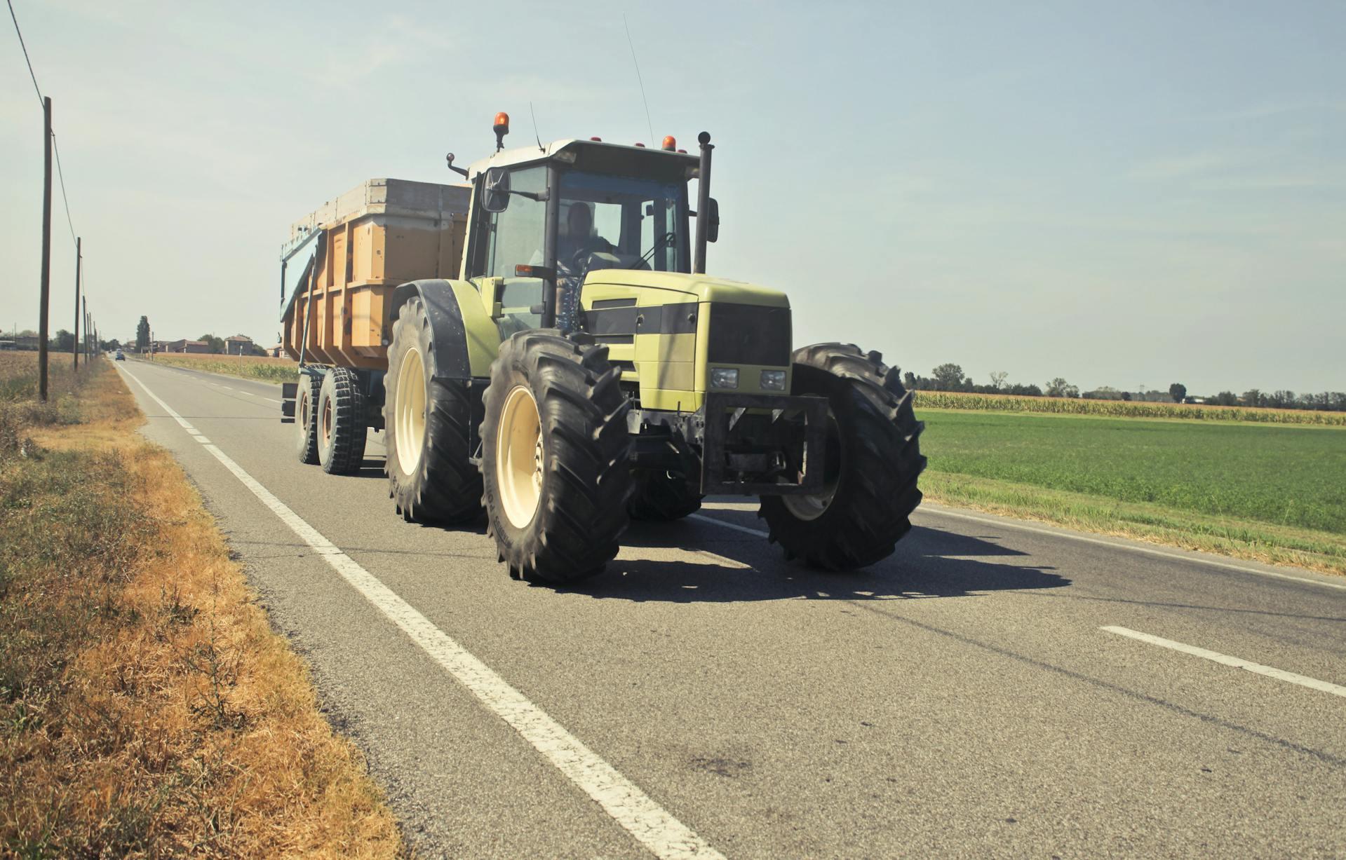 A farming tractor driving on the road