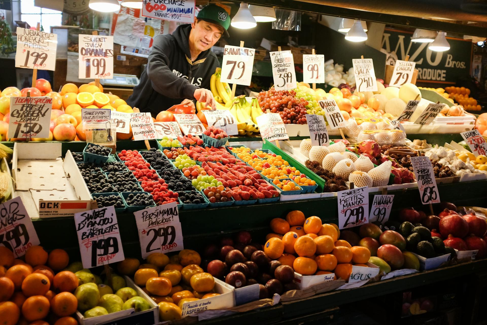 A fruit and vegetable vendor with lots of items and price tags