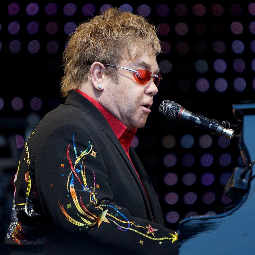 Elton John singing and playing the piano