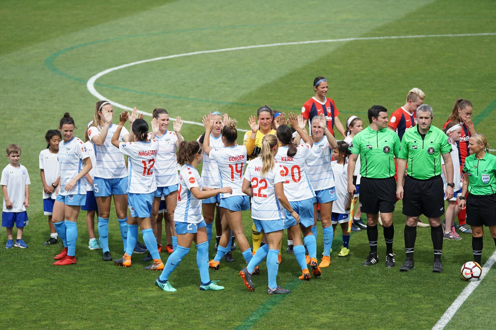 Soccer team high fives.