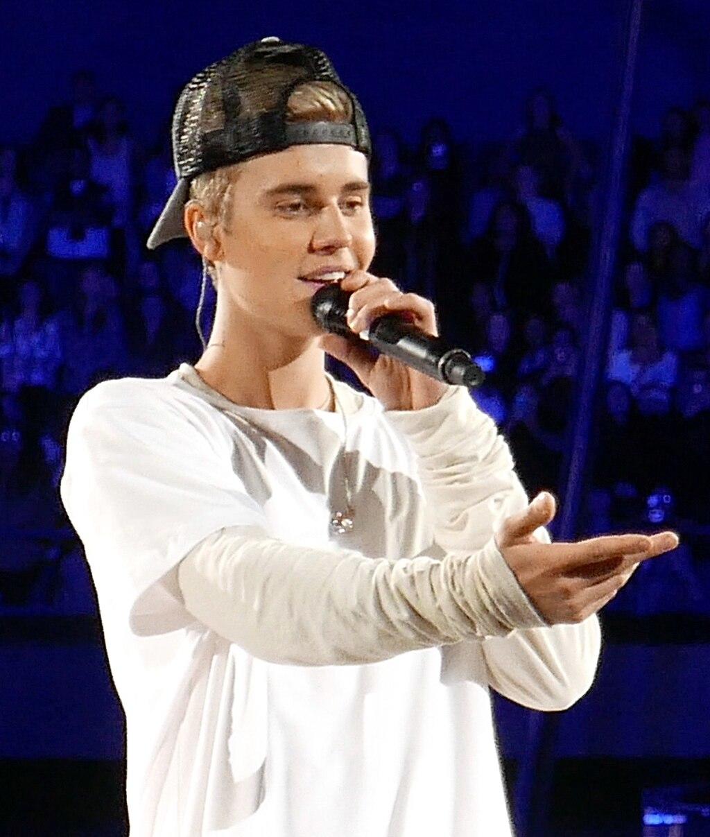 Bieber singing on stage with a mic