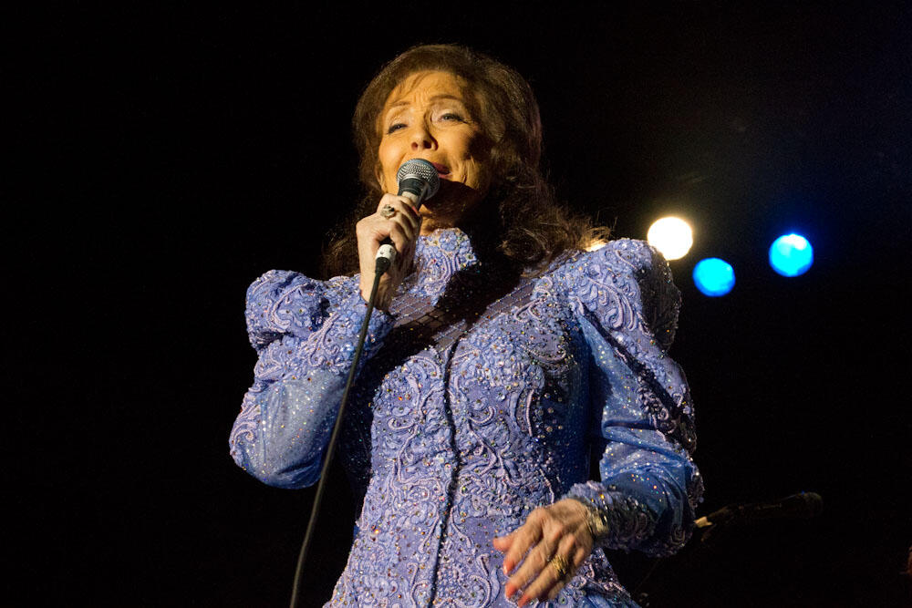 Loretta Lynn performing on stage.