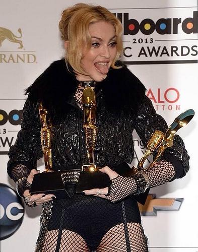Madonna holds three awards she won at the Billboard Music Awards