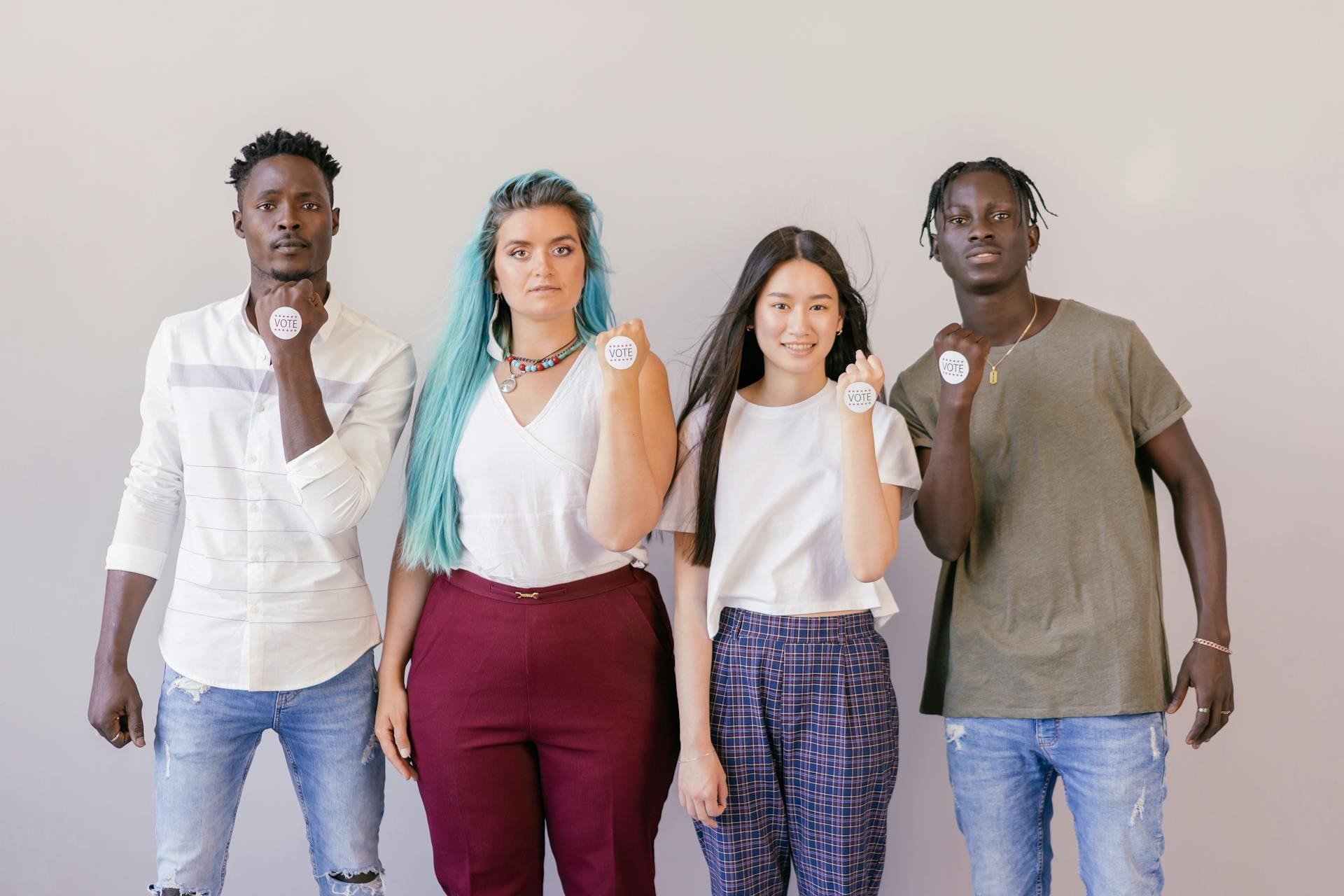 four diverse Americans each with "I voted" stickers