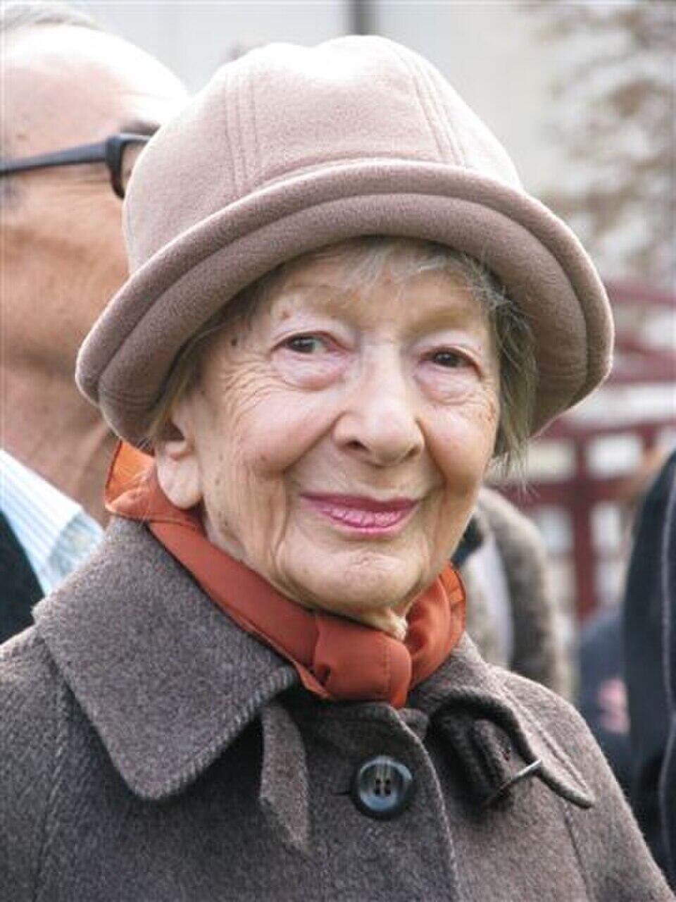 Wisława Szymborska is looking directly into the camera.