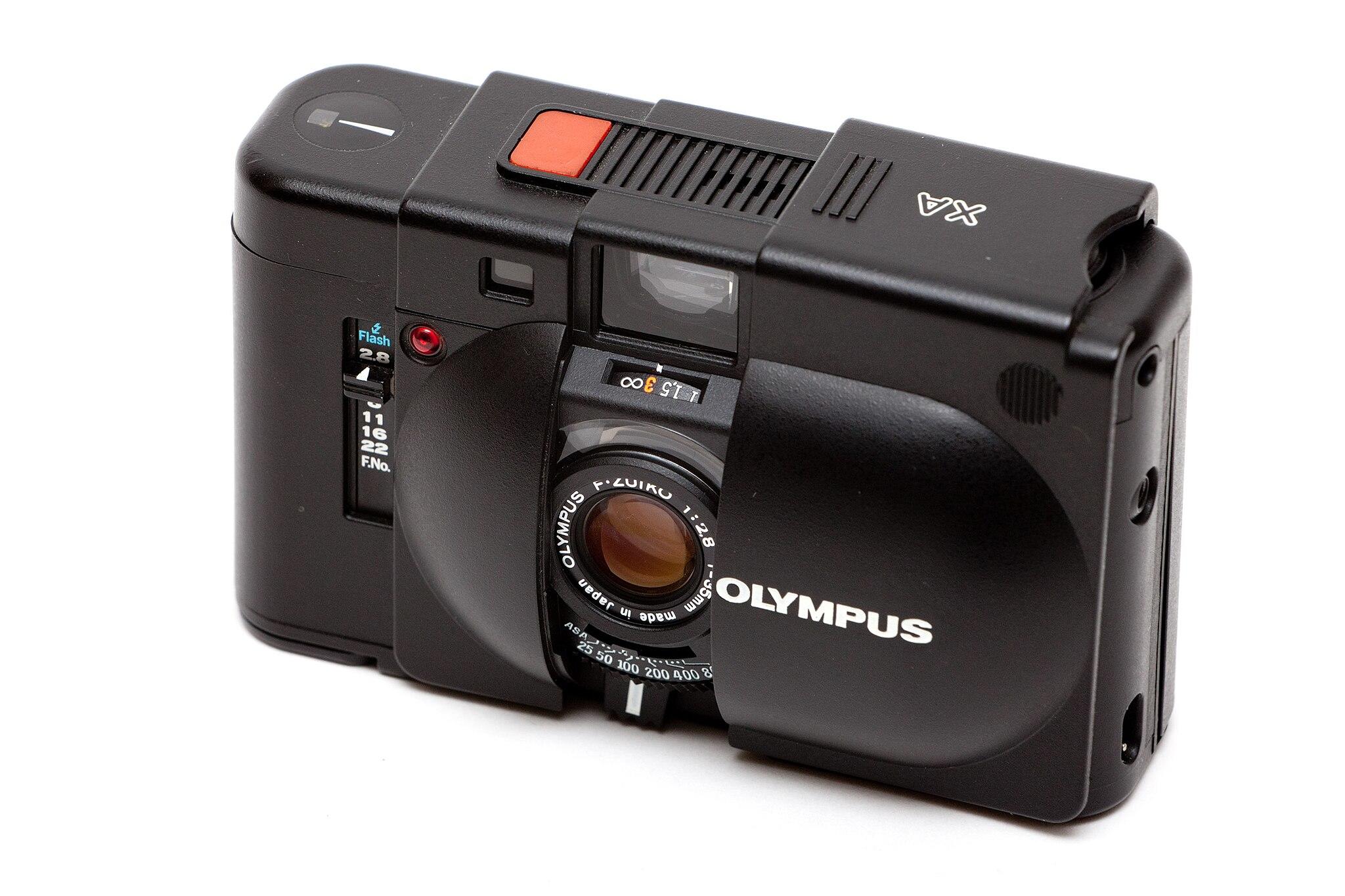 Olympus camera on white background.
