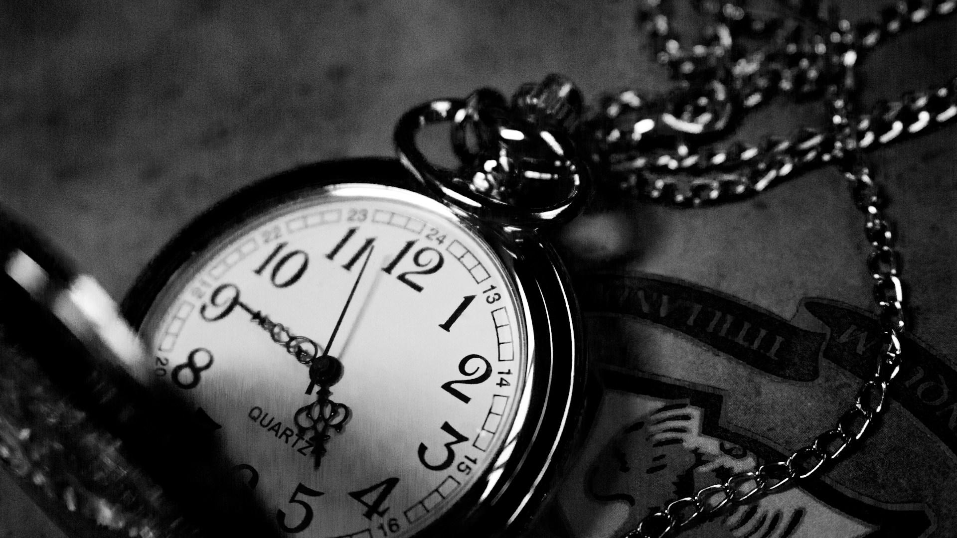 A black and white photo of a pocket watch.