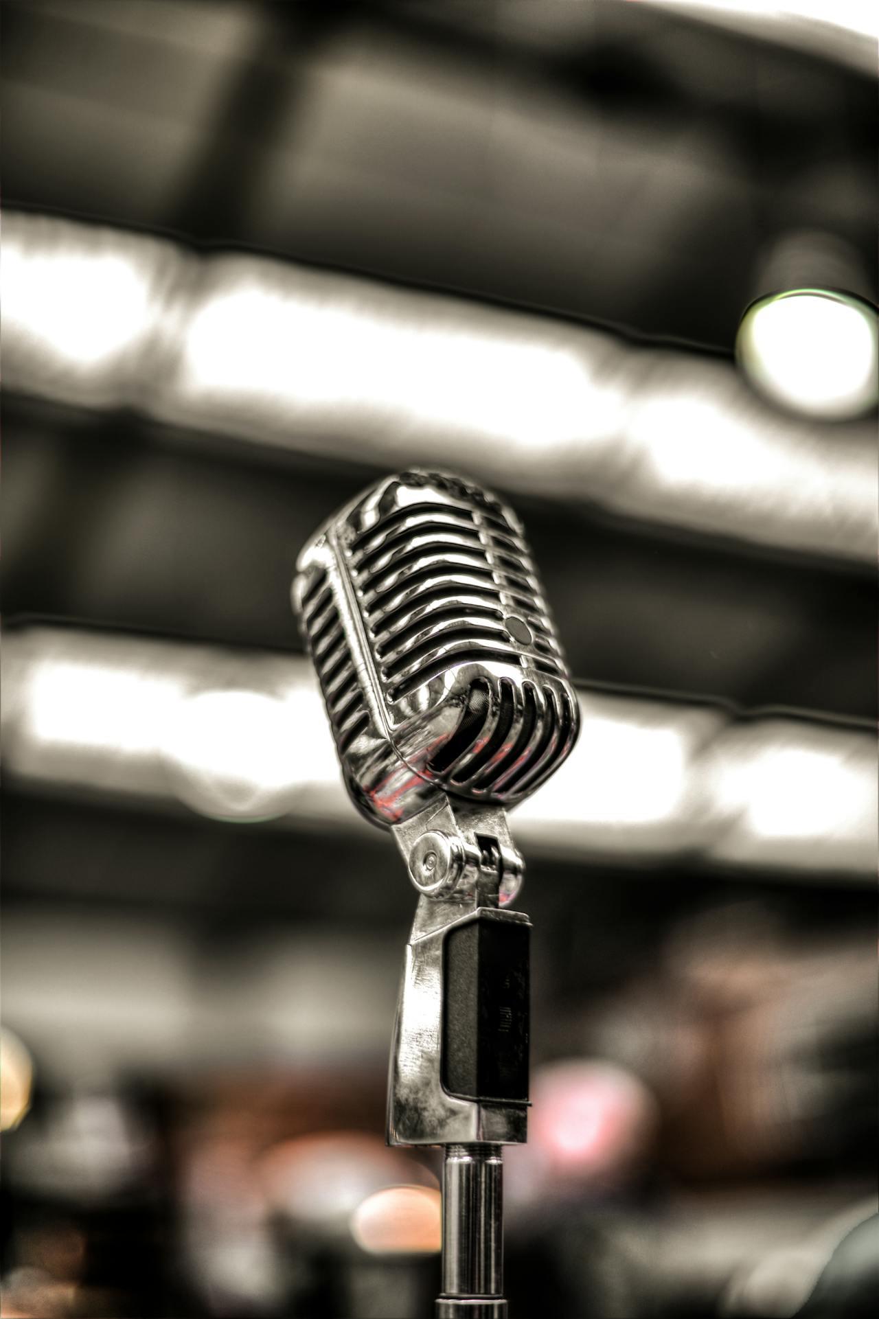 A silver microphone on a stand ready for a performance