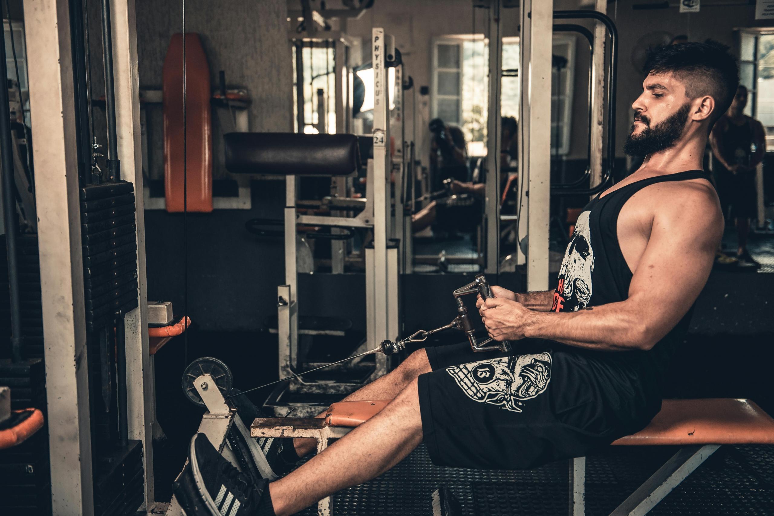 An athlete working towards his fitness goals in a body building gym