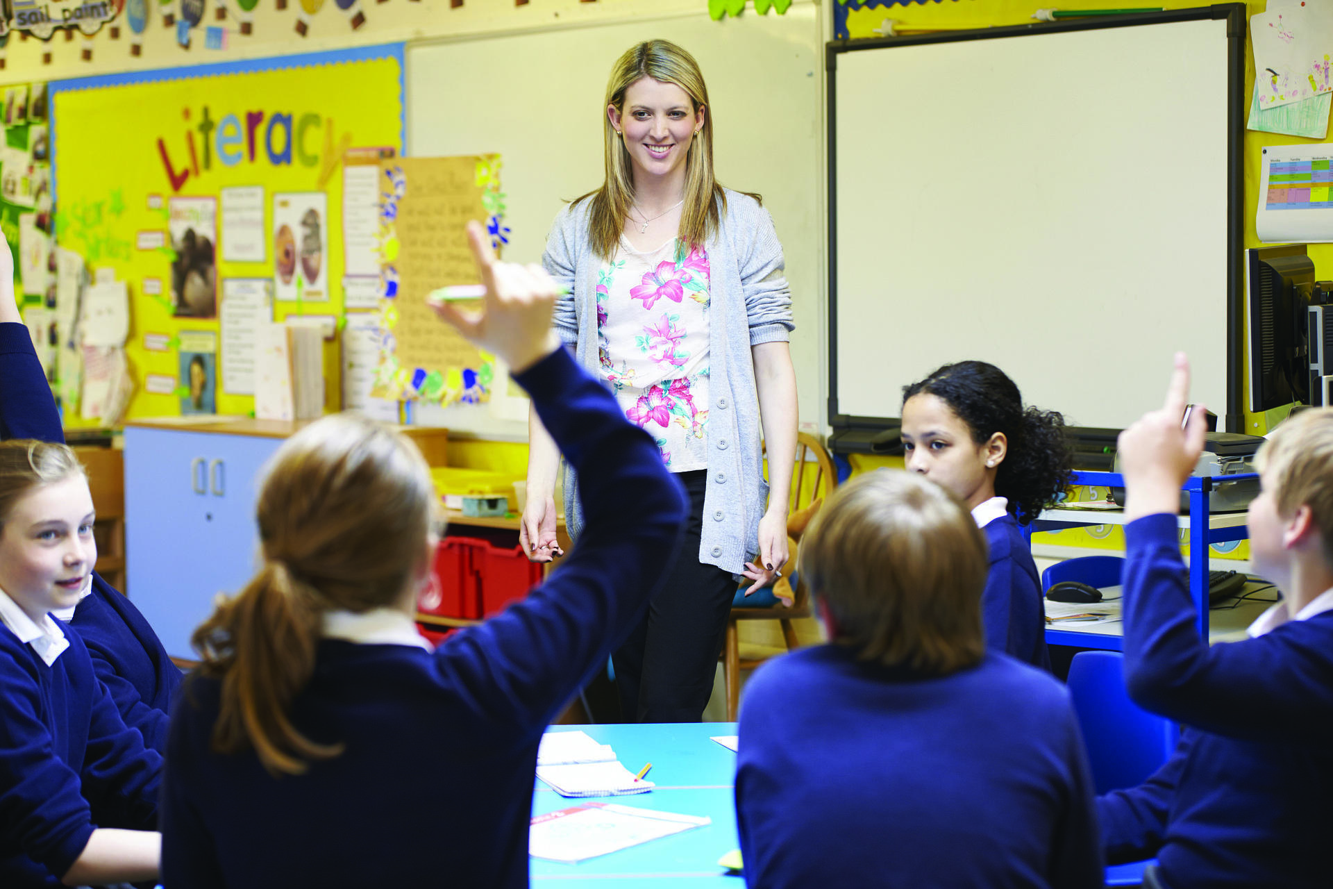 A teacher with students in a classroom.
