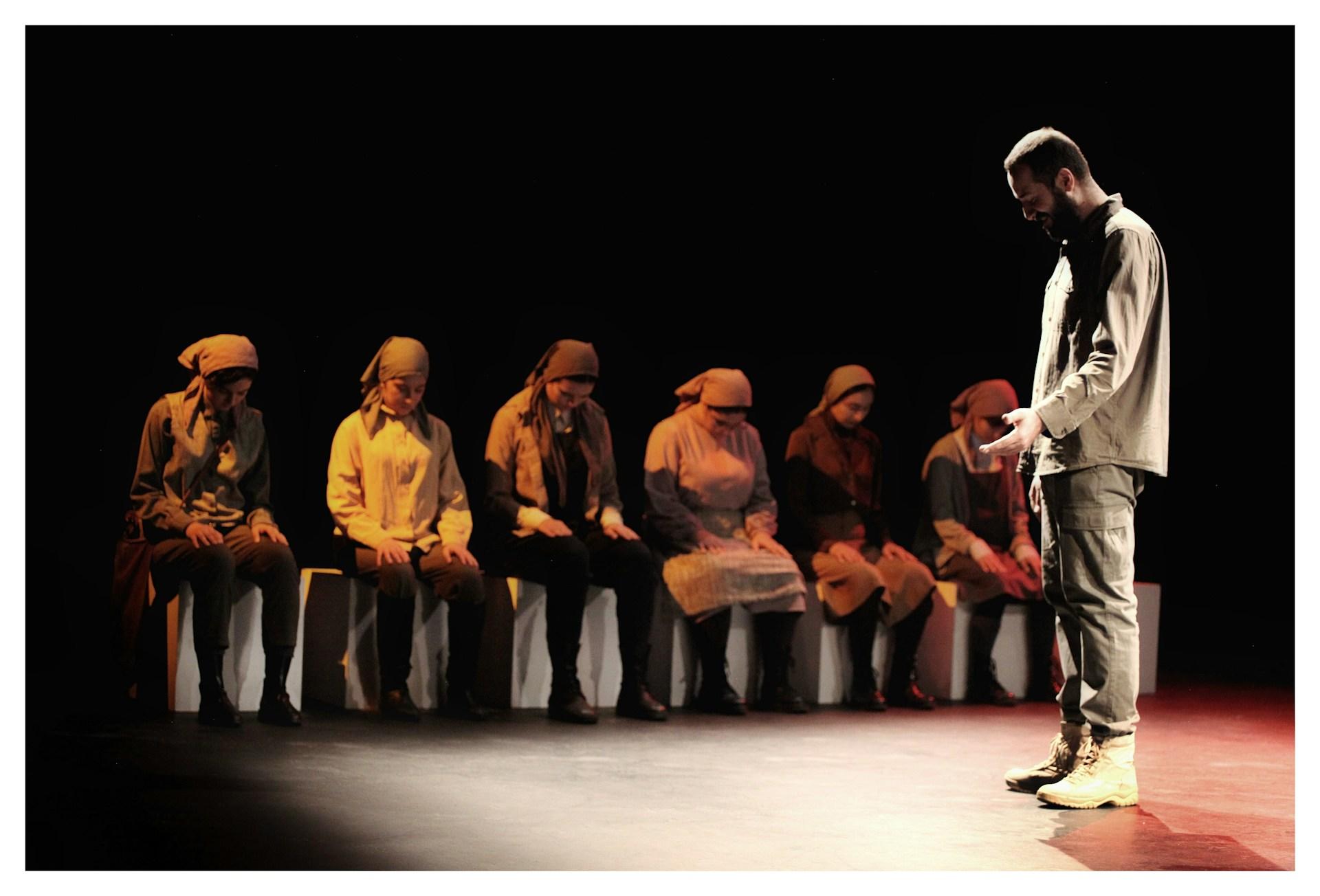 Actors on stage acting out a play.