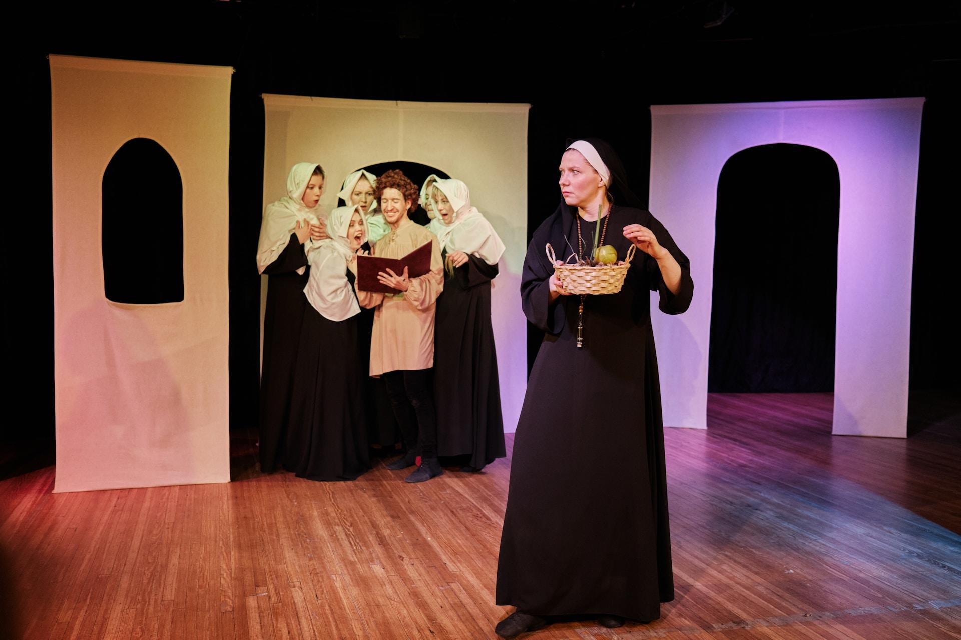 actors on stage acting out a play