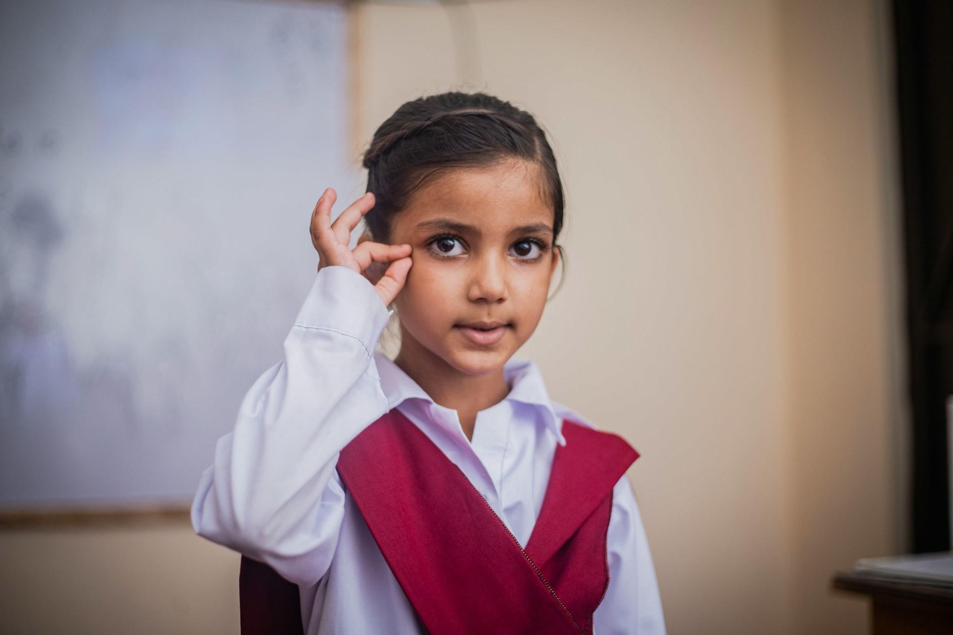 A young girl signing.