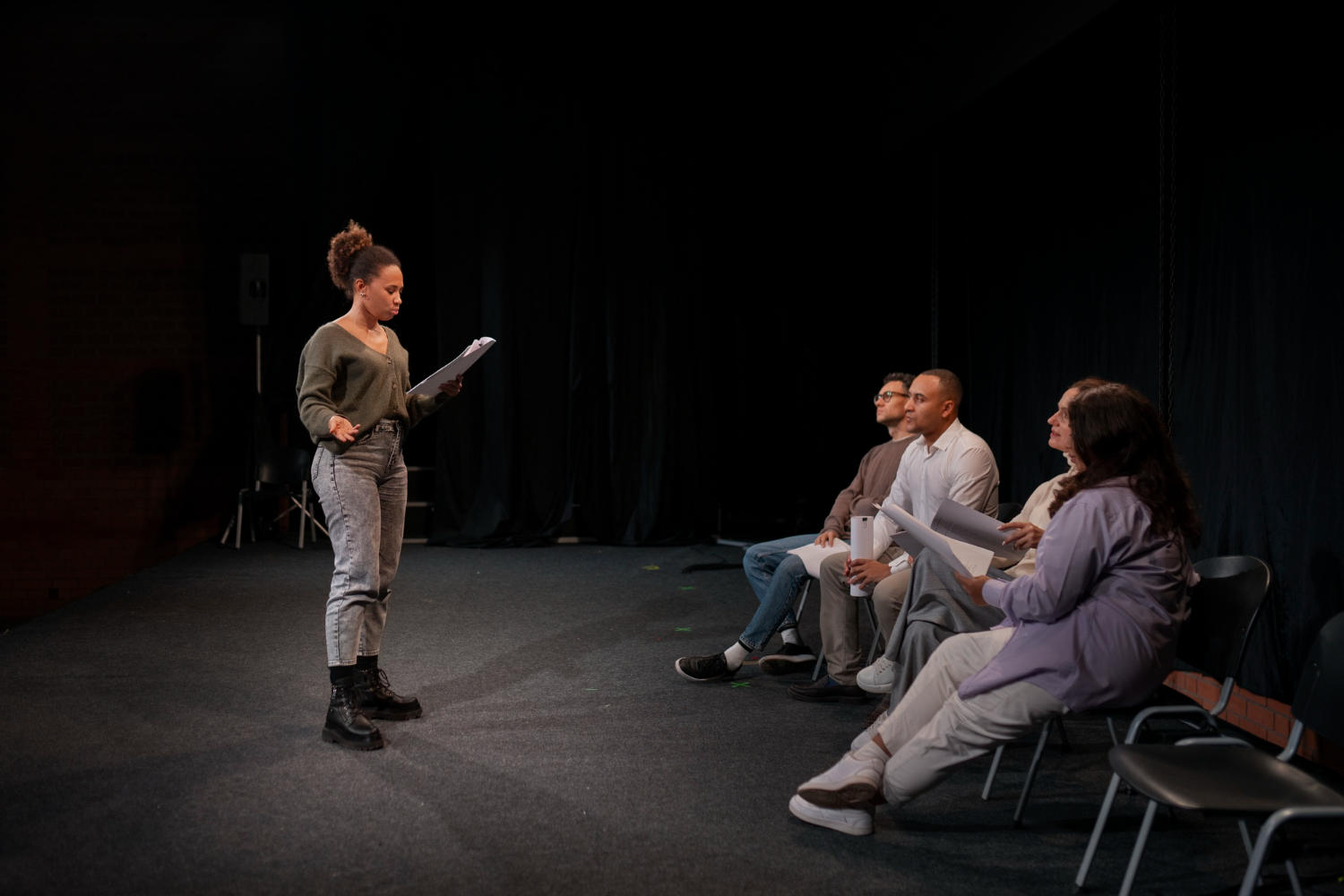 An actress auditioning in front of a panel.