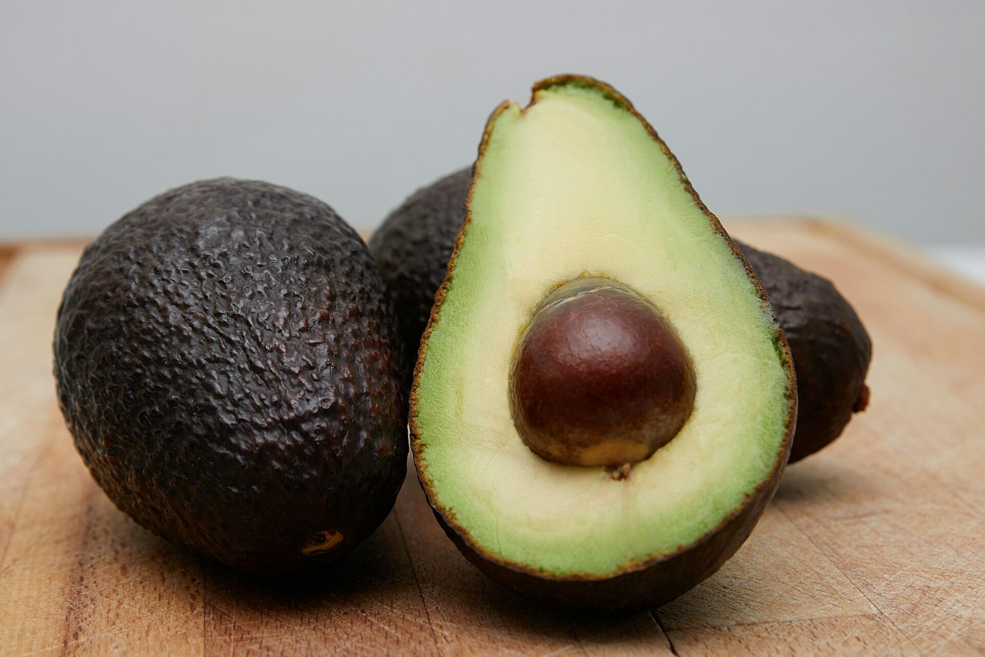 An avocado on a cutting board.