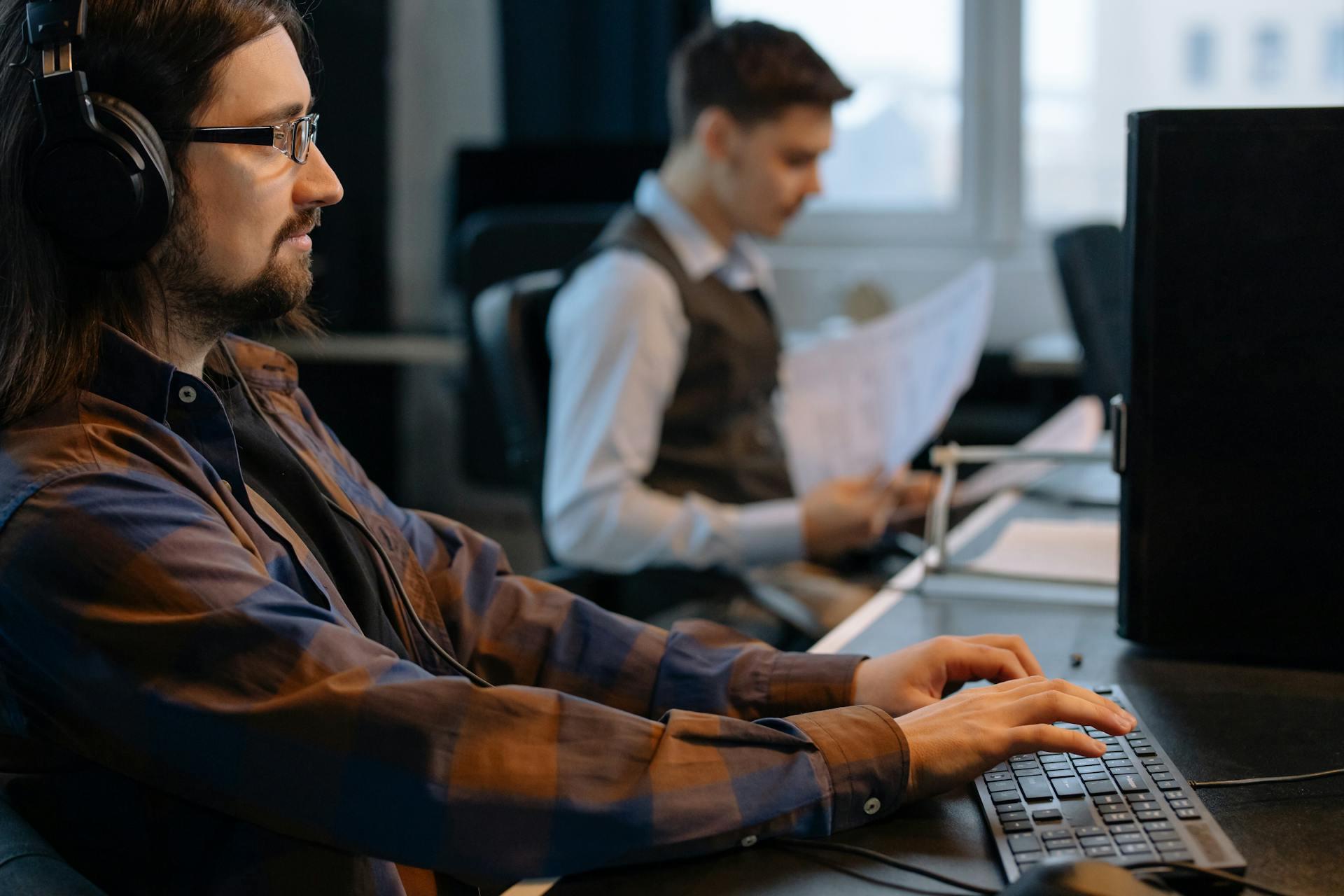 A man sitting at a desk doing work in his day job