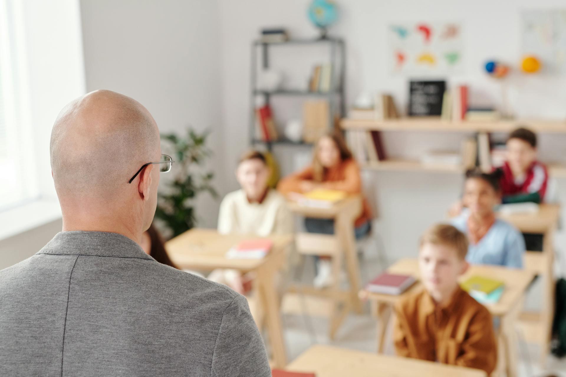 Over the shoulder of a teacher addressing a classroom of students