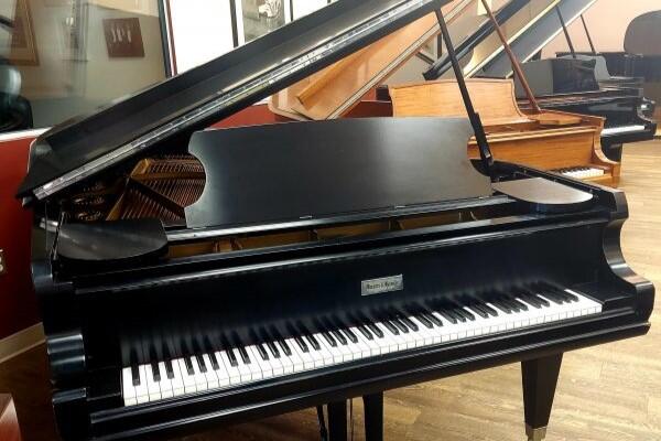 Mason and Hamlin BB grand piano with its lid open in a piano showroom.