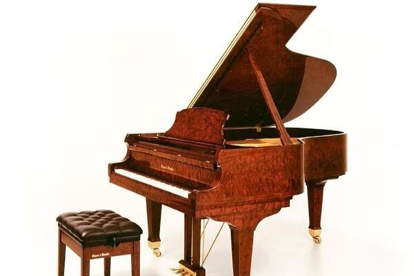 Mason and Hamlin Model AA grand piano in a bubinga wood finish with its lid open.