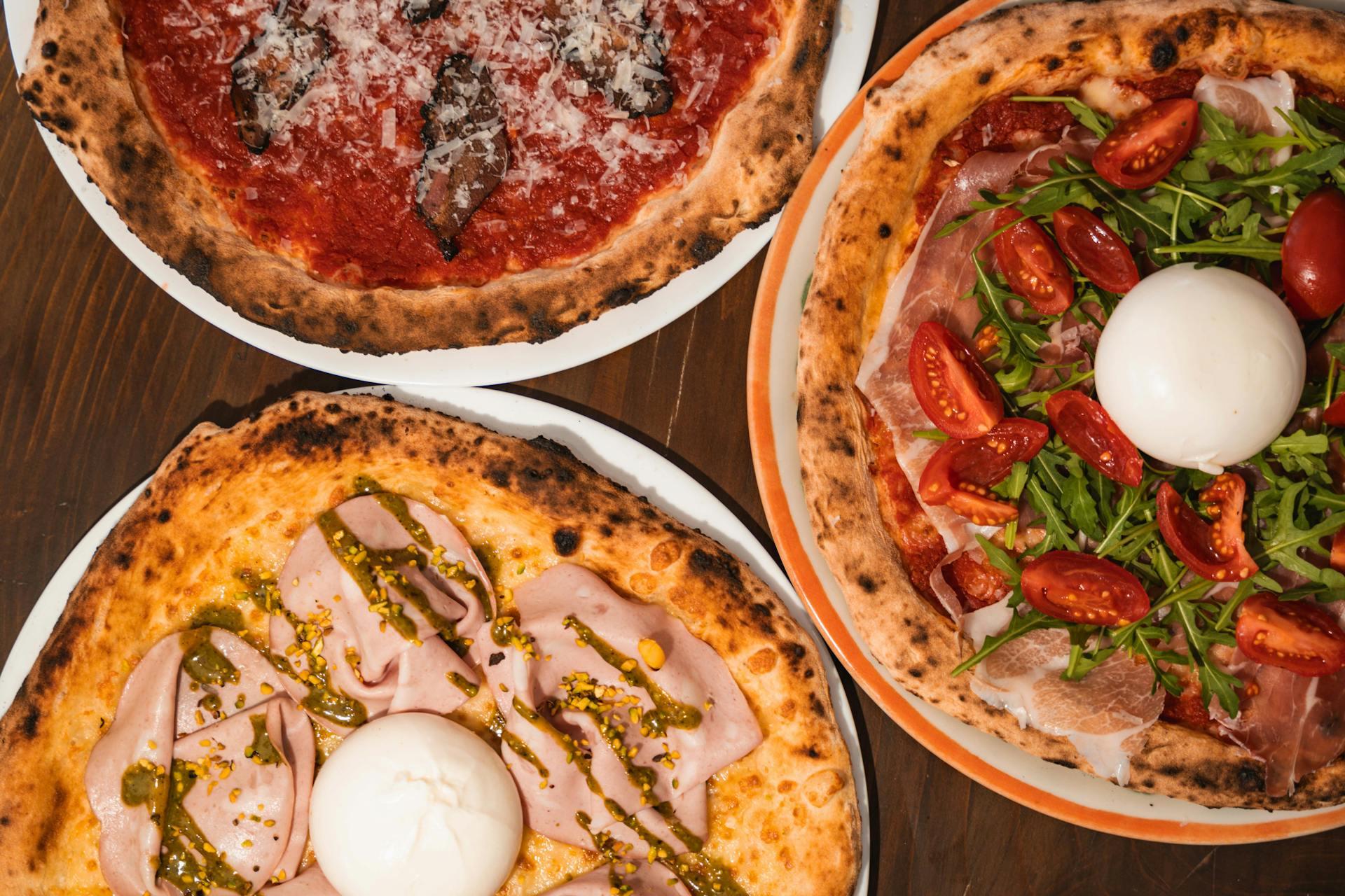 Three different kinds of pizzas.