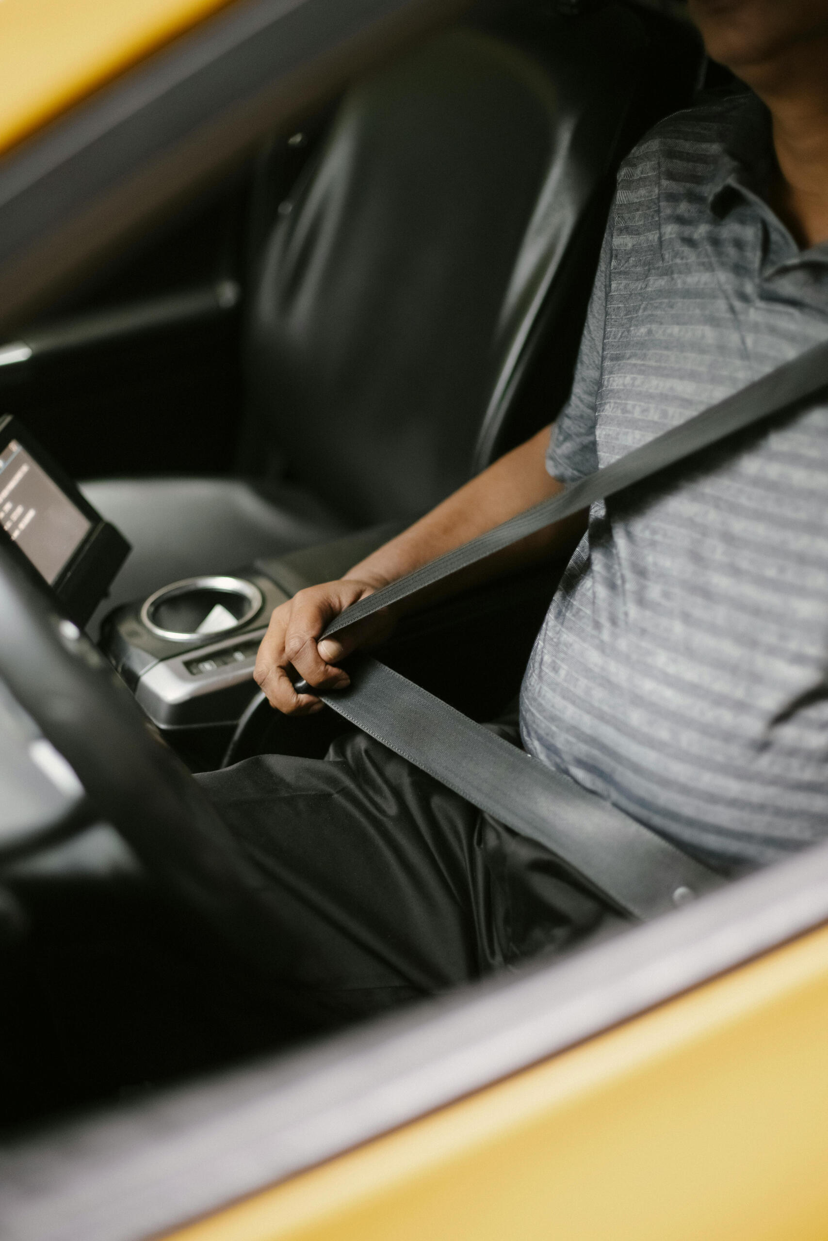 A man fastening seat belt in a vehicle