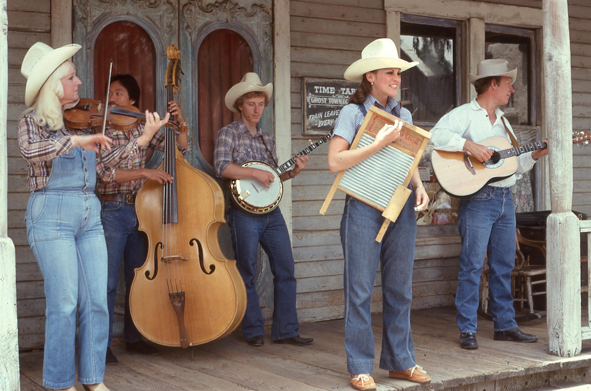 a country band with instruments like banjos, stand-up bass, and a washboard standing on a porch