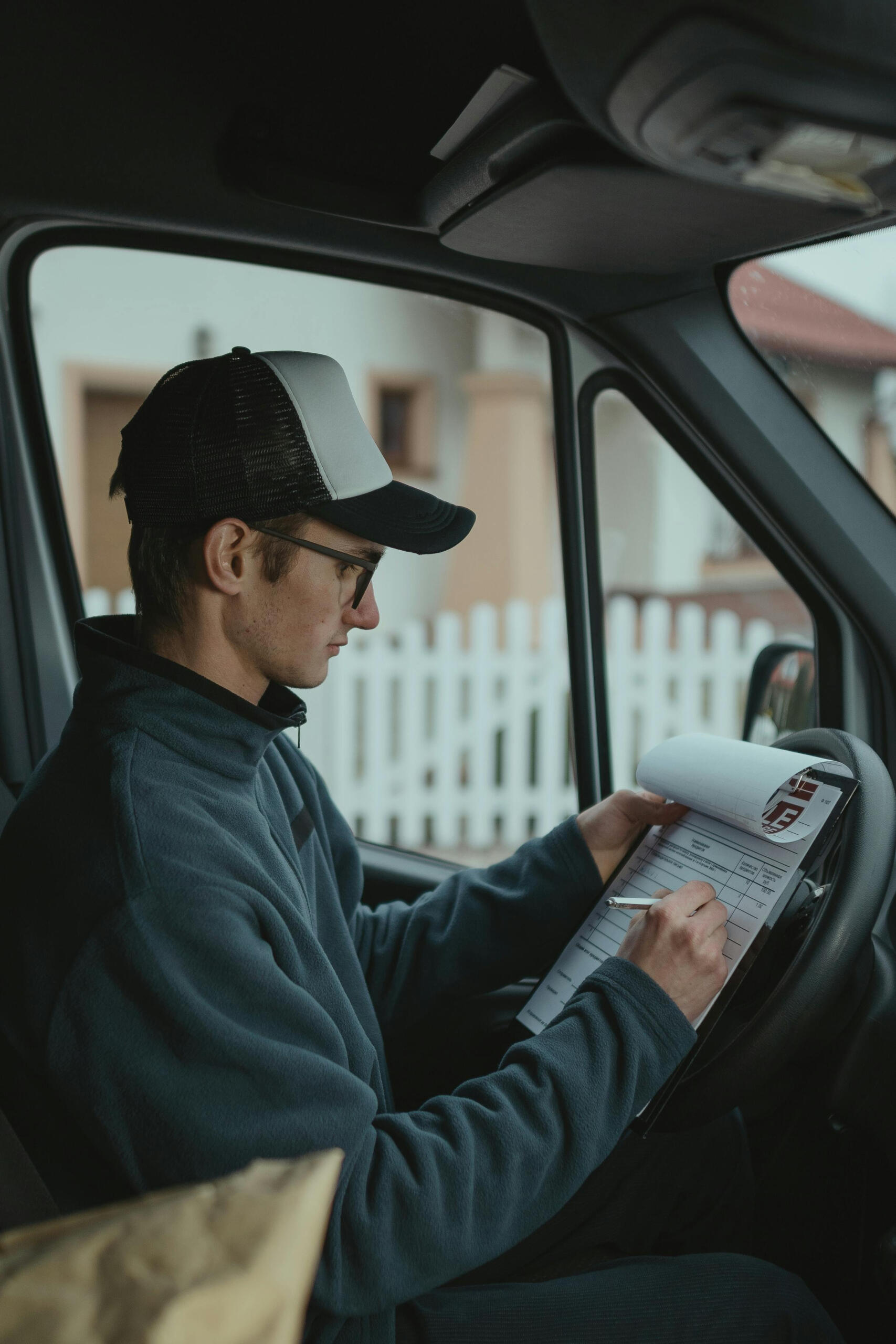 Delivery man writing on paper