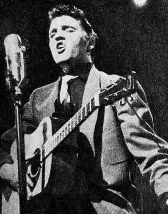 black and white photo of Elvis Presley singing