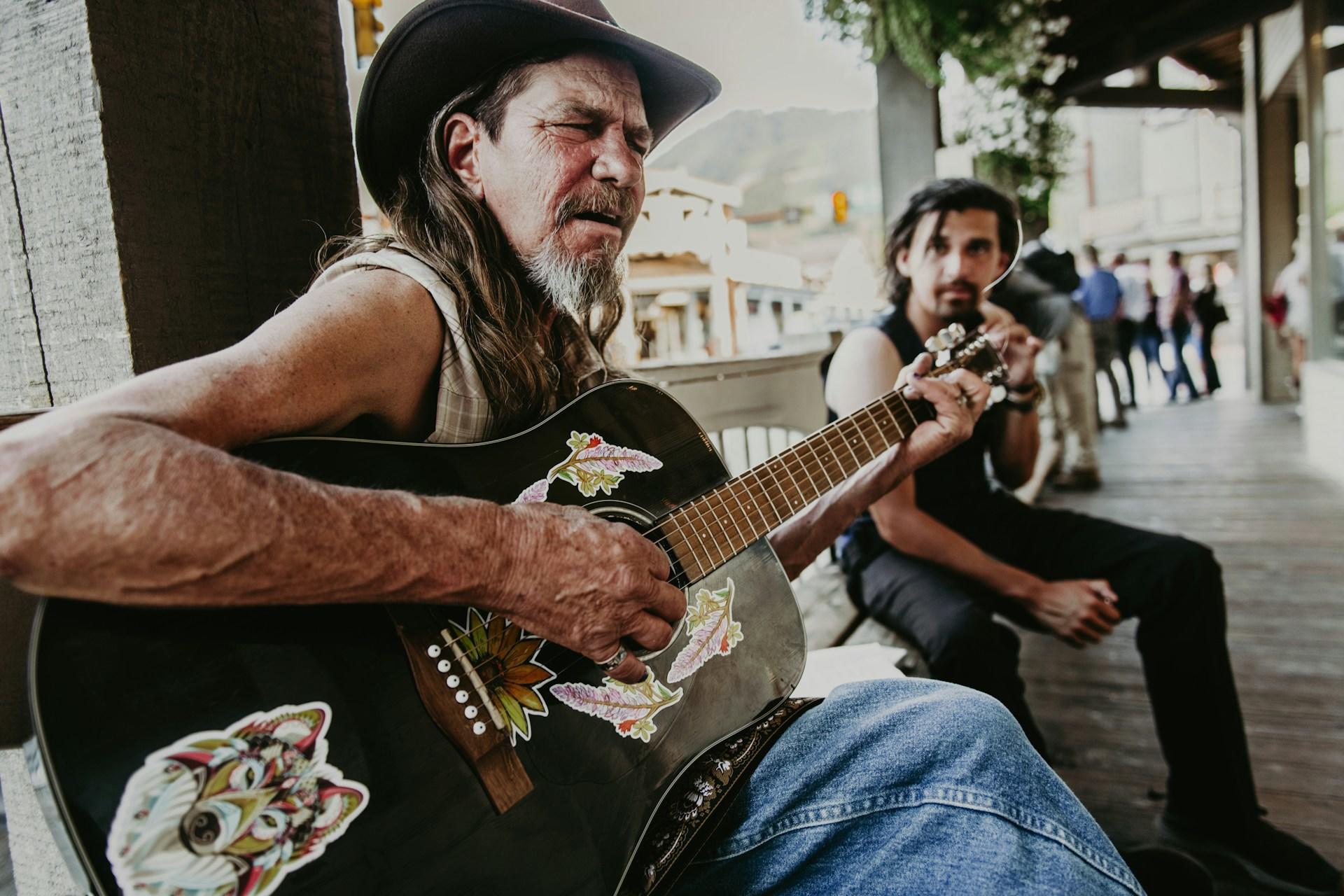 man playing a guitar and singing