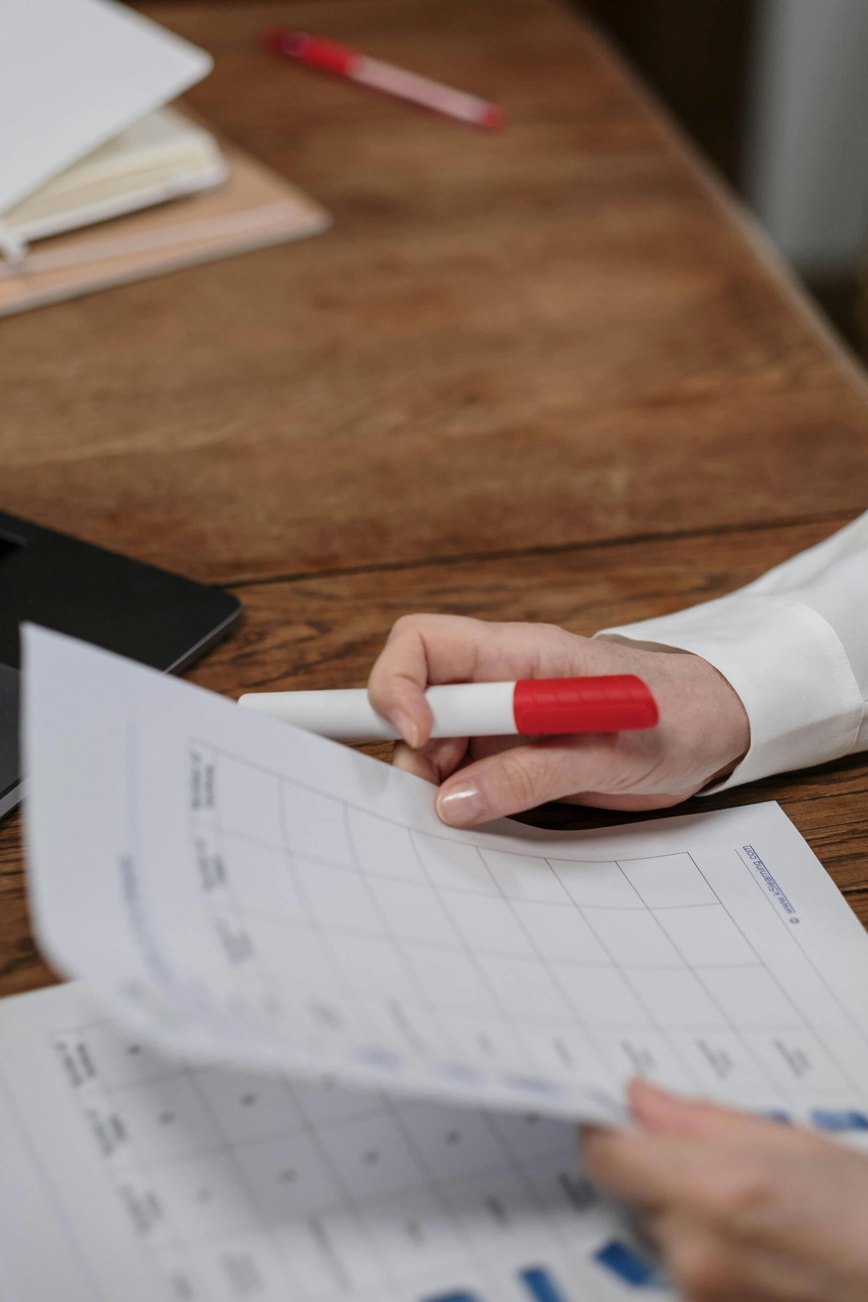 Holding a paper and a marker